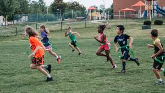 Kids running and participating in flag football at Brier Creek 