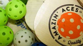 Wooden pickleball paddle and balls