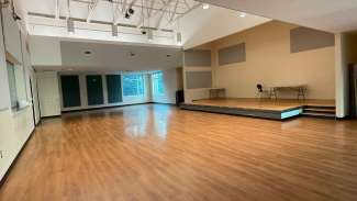 A large meeting room with a stage 