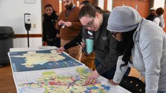 Two people looking at city plan documents