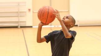 a child shooting a basketball